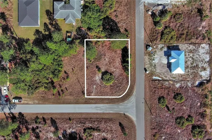 Aerial view of property and surrounding area with property boundaries highlighted