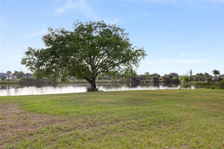 View of grassy yard with a water view