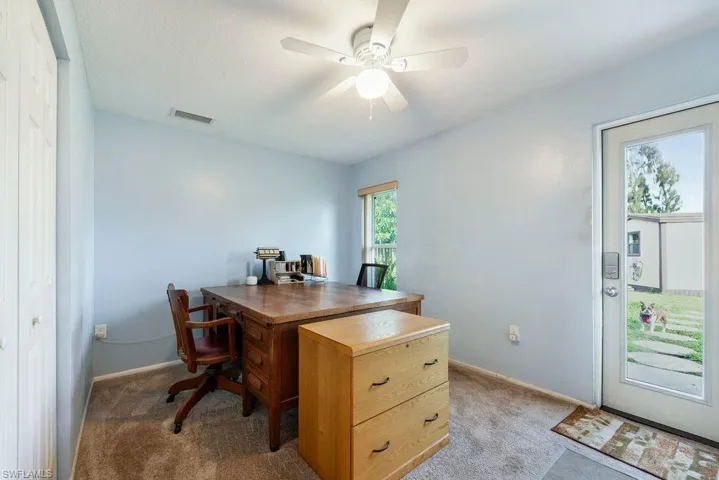Home office featuring carpet flooring and a ceiling fan