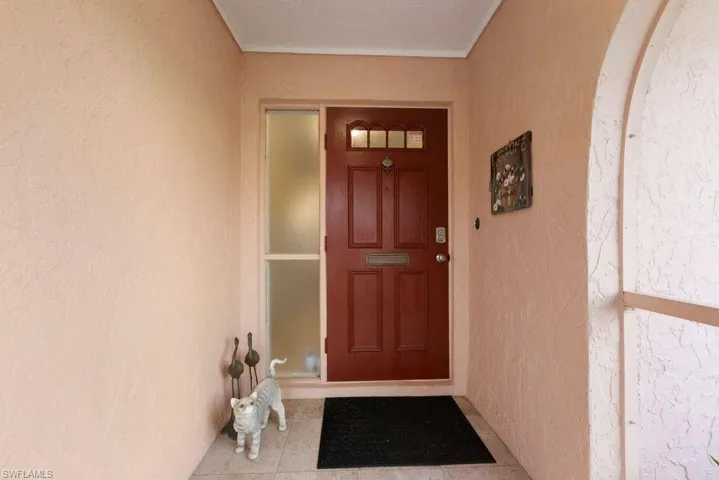 Doorway to property featuring stucco siding