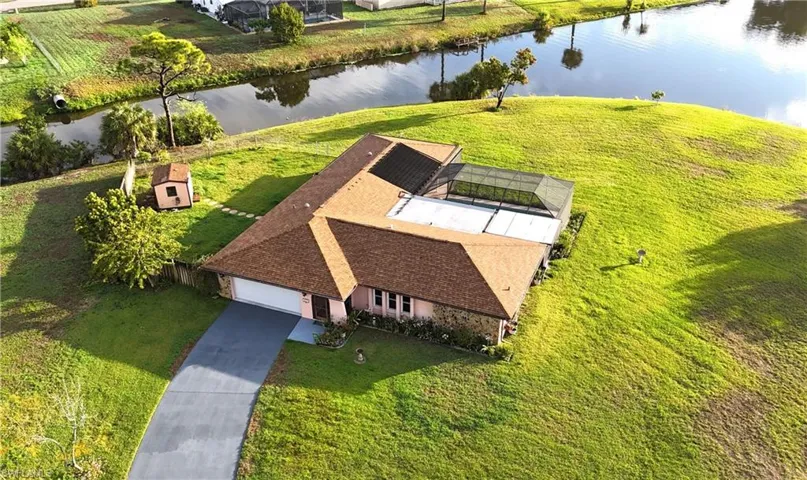 Aerial view of property and surrounding area featuring a large body of water