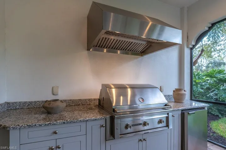 lanai with summer kitchen, grill, and beverage cooler