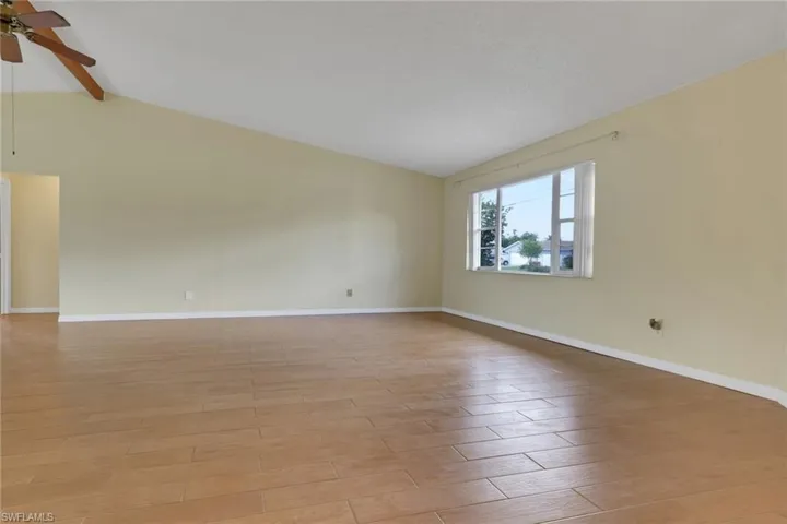 Spare room with light wood finished floors and ceiling fan