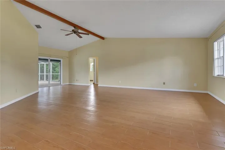 Empty room featuring plenty of natural light, light wood finished floors, and ceiling fan