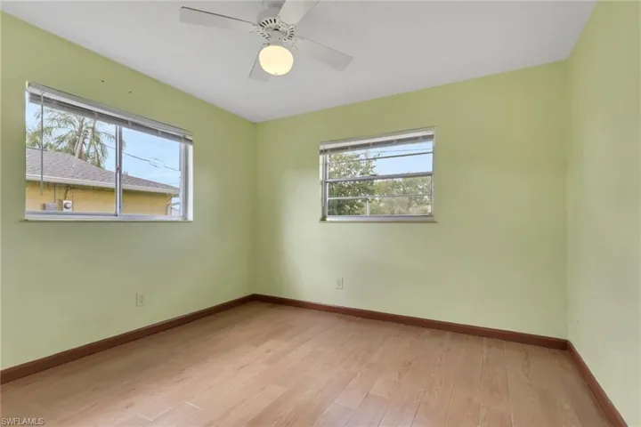 Unfurnished room featuring light wood-style flooring and a ceiling fan