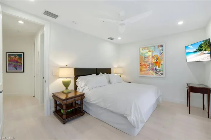 Bedroom with light hardwood / wood-style floors and ceiling fan