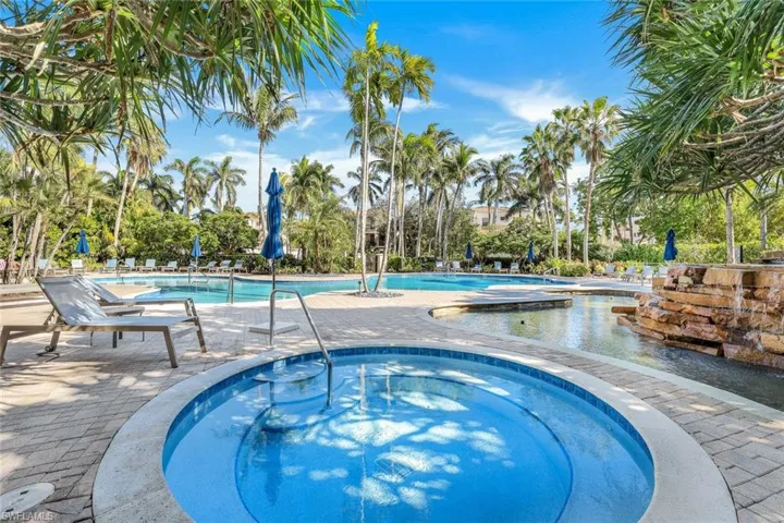 View of pool with a community hot tub and a patio