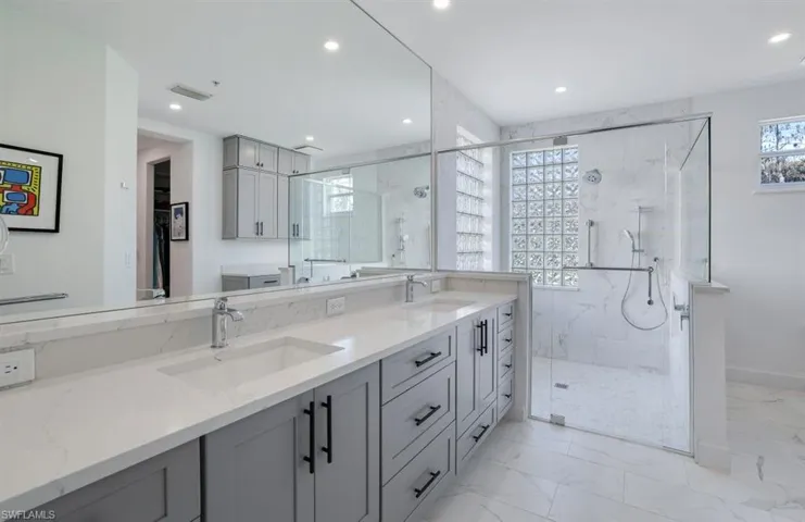 Bathroom featuring vanity and an enclosed shower