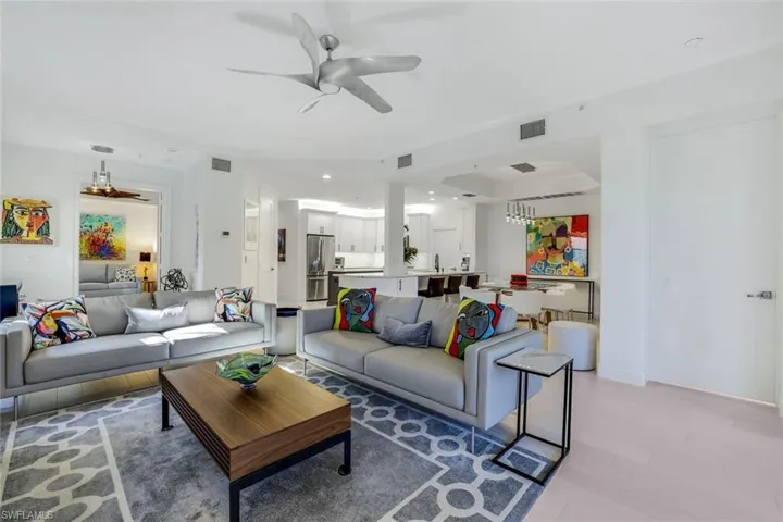 Living room with ceiling fan and light hardwood / wood-style floors