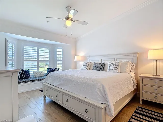 MASTER BEDROOM WITH KING SIZE BED, LIGHT COLOR FLOORING & SITTING AREA WITH BENCH