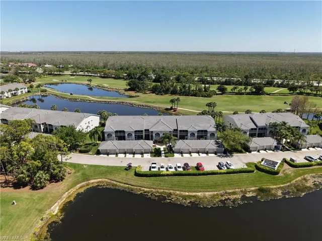 Drone / aerial view featuring a water view and view of golf course