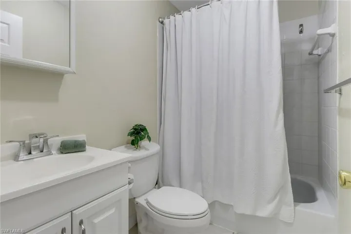 Full bath with shower / bath combination with curtain and vanity