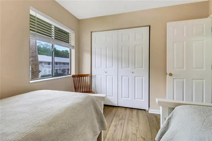 Bedroom featuring light wood finished floors and a closet