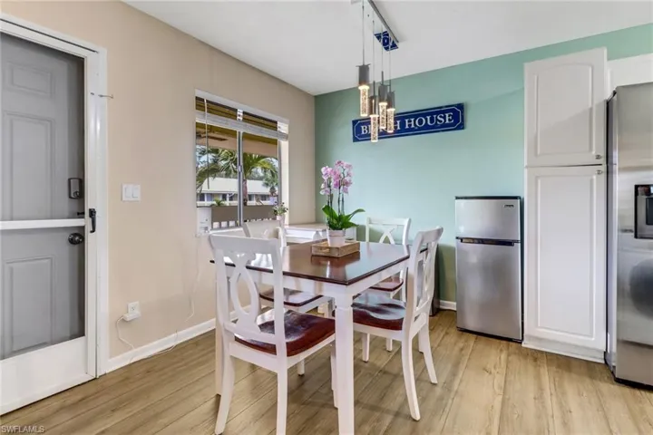 Dining space with light wood finished floors and a chandelier