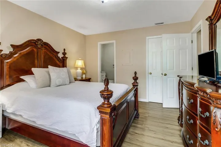 Bedroom featuring light wood-style floors and ensuite bathroom