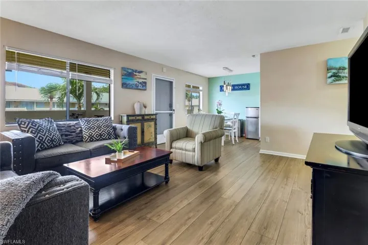 Living room featuring light wood-style flooring and baseboards