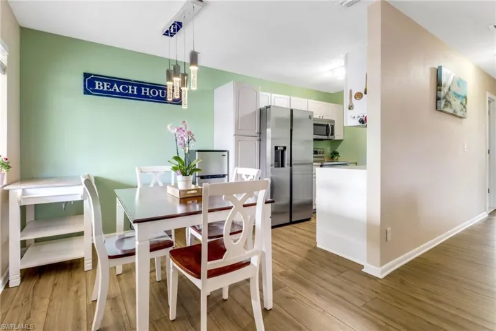 Dining room featuring light wood-type flooring and a chandelier
