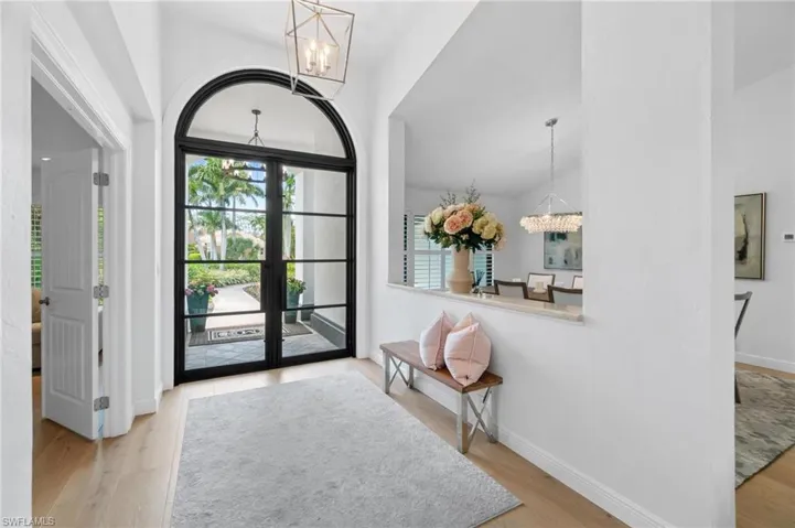 Entryway with a chandelier and light wood-type flooring
