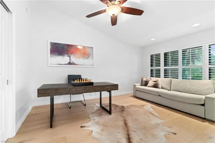 Office with light wood-style floors, lofted ceiling, ceiling fan, and recessed lighting
