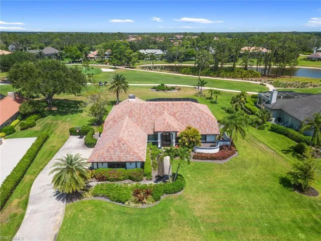 View of subject property featuring a local golf course and a large body of water