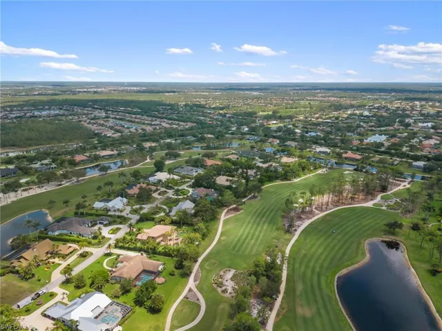 View of property location with a large body of water, nearby suburban area, and a golf course
