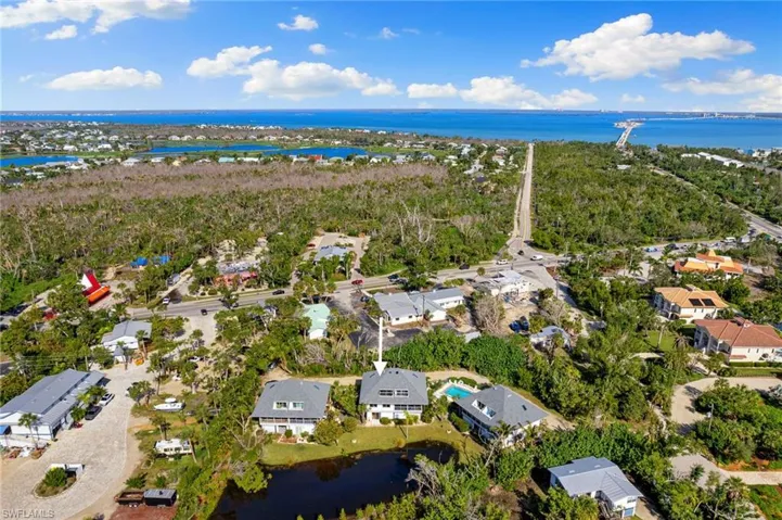 Aerial view of property's location featuring nearby suburban area and a large body of water