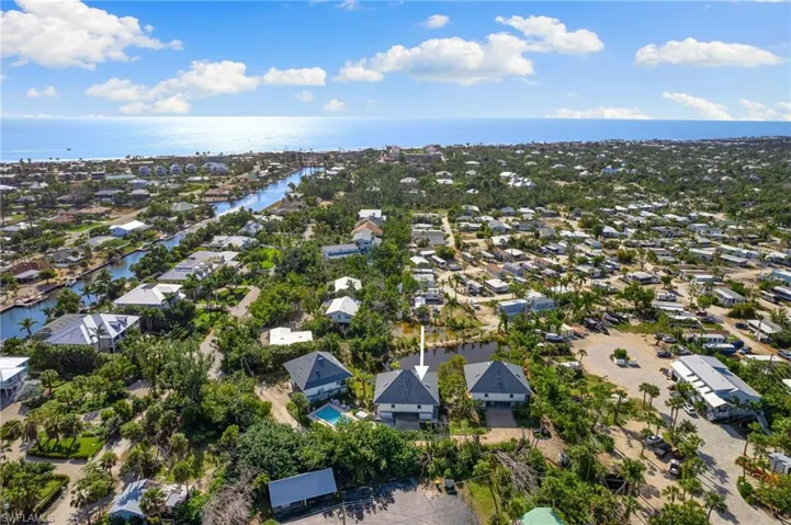 Aerial perspective of suburban area featuring a large body of water
