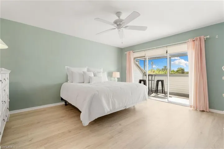 Bedroom with access to outside, light wood finished floors, and ceiling fan