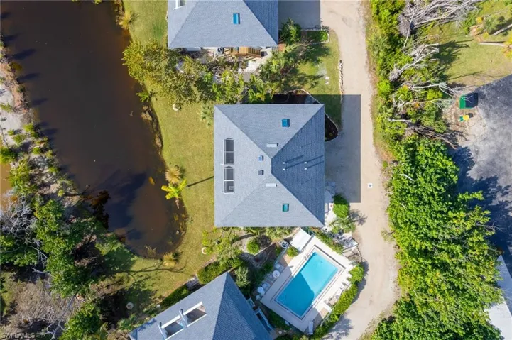 Drone / aerial view of a large body of water and a pool area