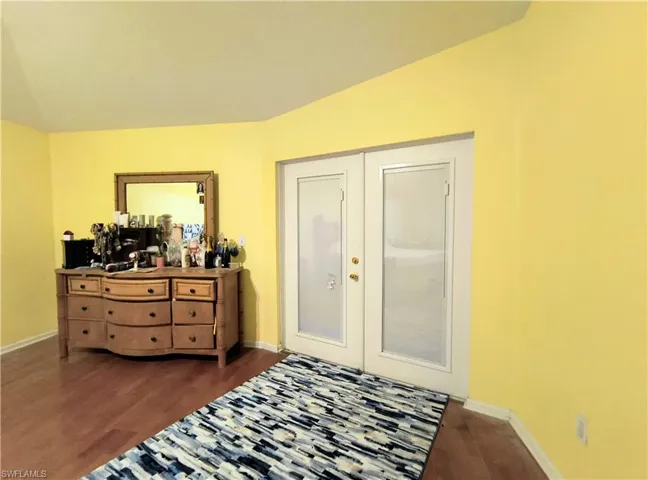 Bedroom with french doors to lanai and pool.