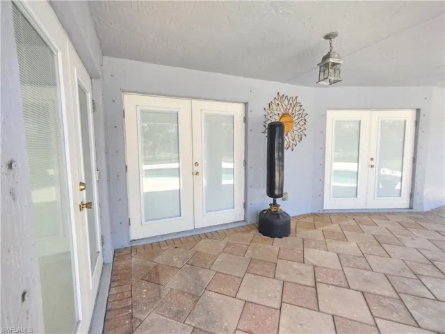 View of exterior entry to lanai featuring french doors