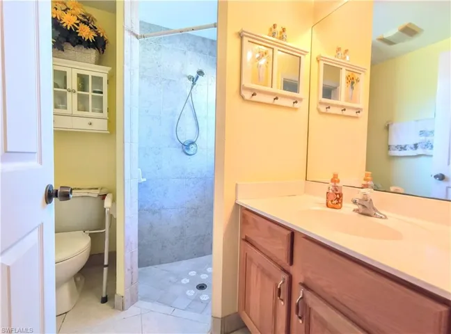 Bathroom 3 - Guest House - with tile floors, a tile shower, vanity, and toilet