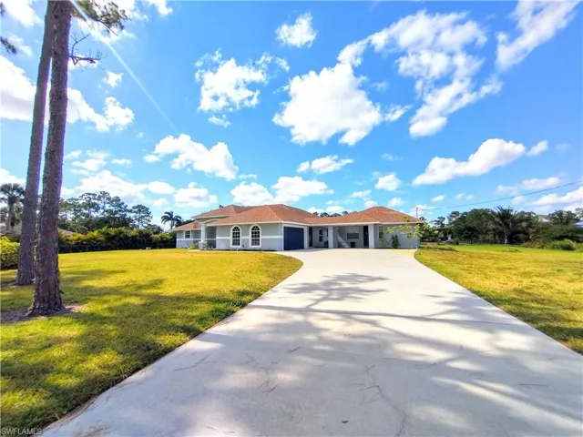 View of front of property featuring a concrete driveway