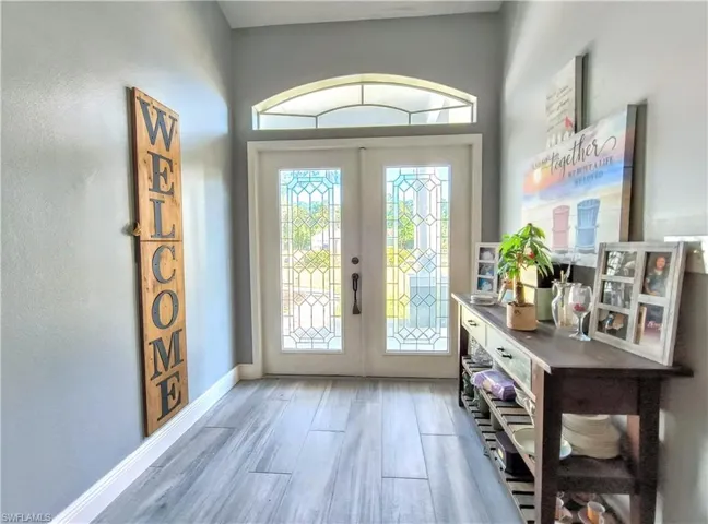 Doorway featuring hardwood / wood-style tile floors and french doors