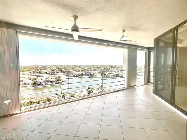 Balcony with a water view and ceiling fan