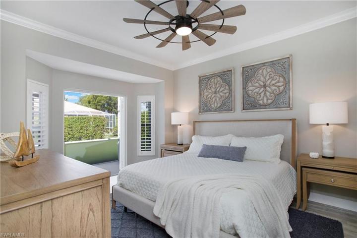 Large primary bedroom with french doors to lanai
