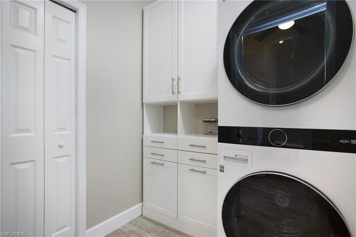 Laundry room with cabinet and closet storage