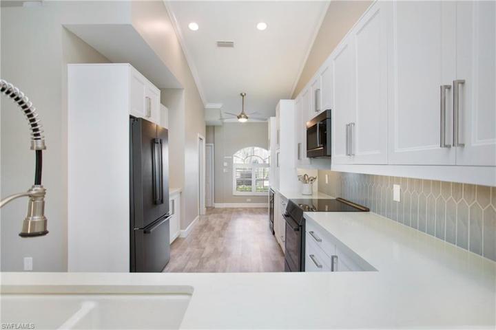 Sleek kitchen with shaker soft close cabinets, quartz counters, procelein backsplash
