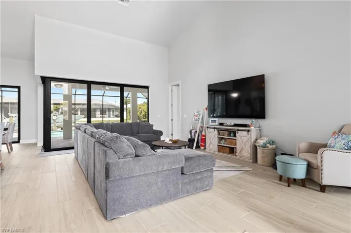 Living area featuring vaulted ceiling and wood finish floors
