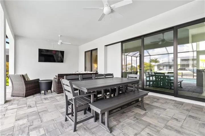Dining room featuring a sunroom and a ceiling fan