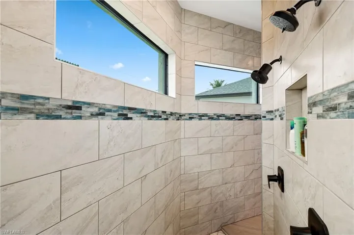 Bathroom featuring a tile shower
