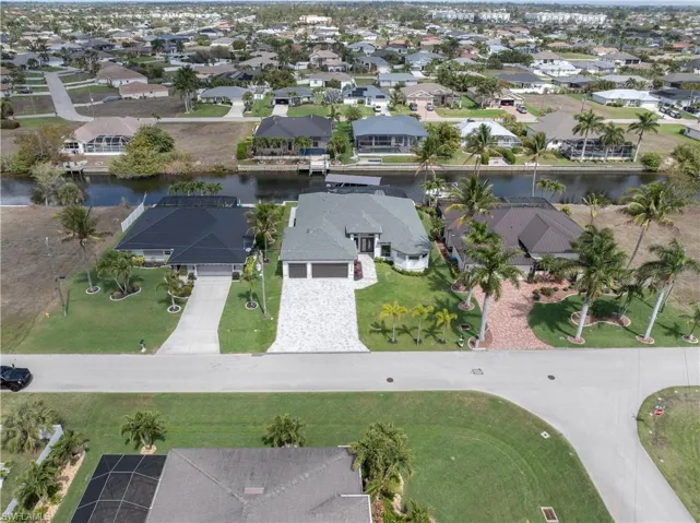Aerial perspective of suburban area featuring a large body of water