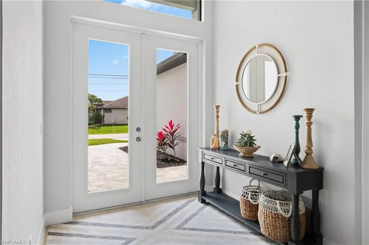 Foyer entrance featuring french doors and a textured wall