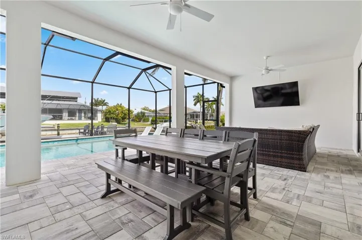 View of patio / terrace featuring ceiling fan, an outdoor pool, glass enclosure, a sunroom, and outdoor lounge area