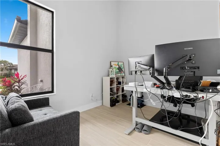 Office area with light wood-style floors and baseboards