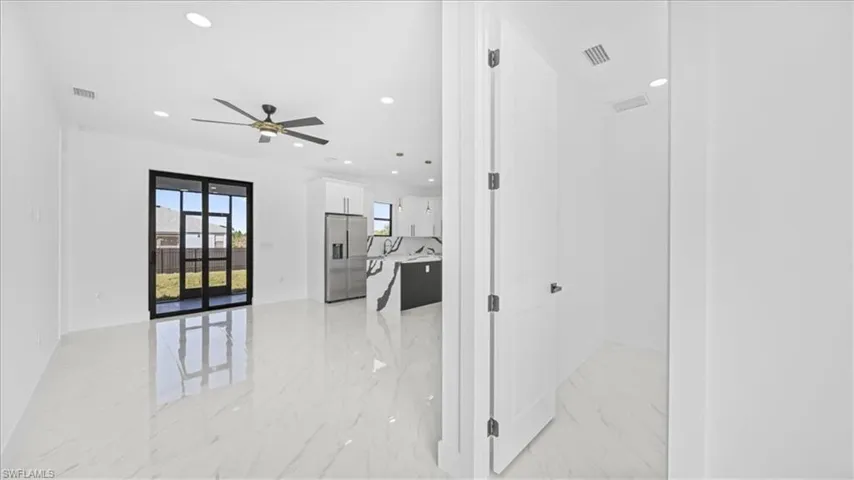 Hall with recessed lighting and light marble finish flooring