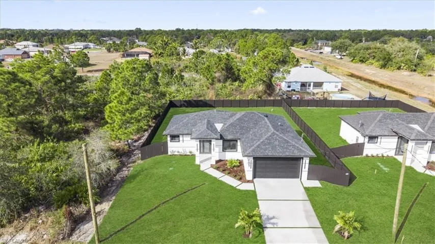 View from above of property with a tree filled landscape