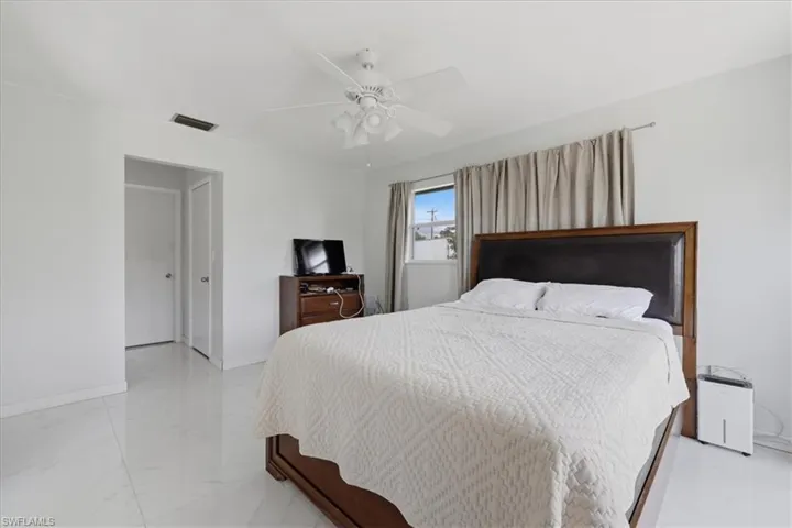Bedroom with baseboards and ceiling fan