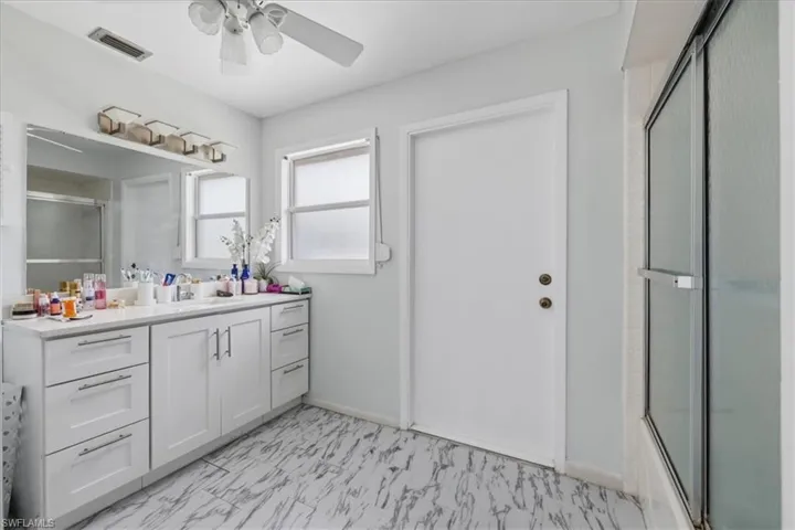 Full bath featuring vanity and ceiling fan