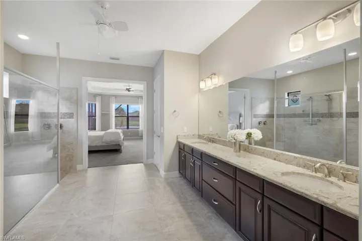Bathroom with dual vanity, and double tiled shower